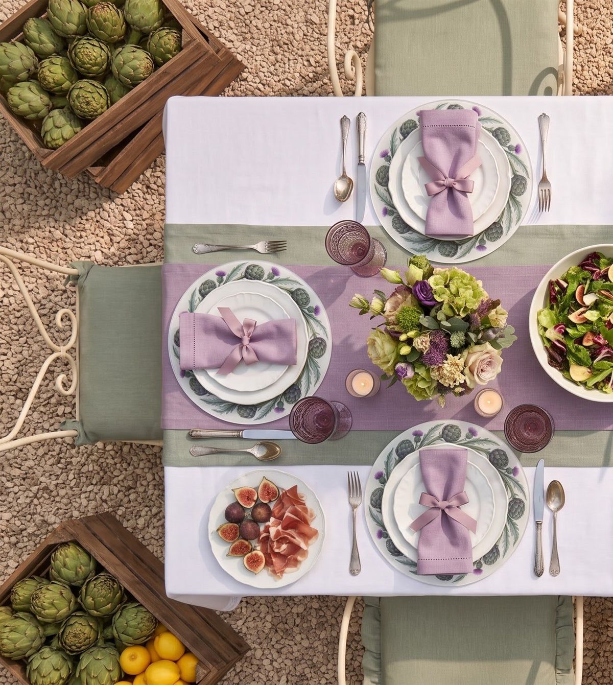 Artichoke placemats on a laid table, seen from above