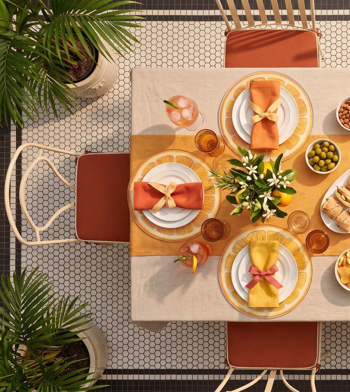 Table set with Garnish one big slice of orange placemats, seen from above