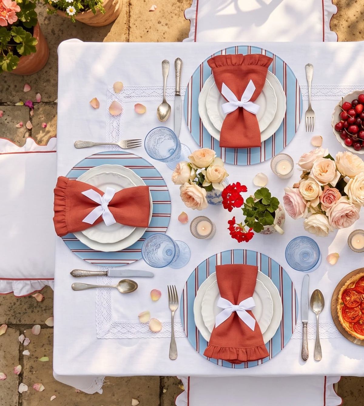 Sienna Blue Cabana Stripe placemats on a laid table, seen from above