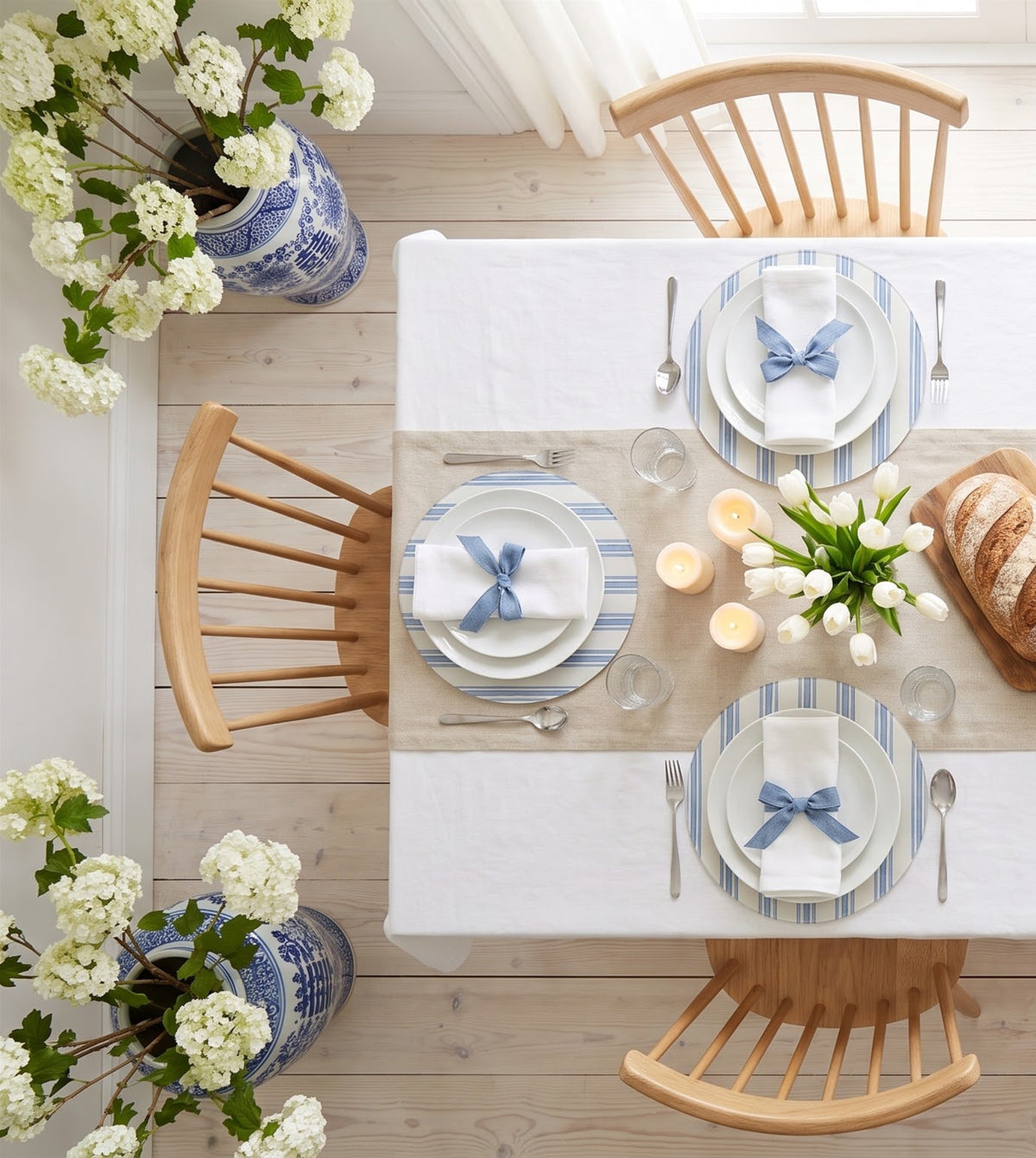 Blue Ticking Stripe placemats on a laid table, seen from above